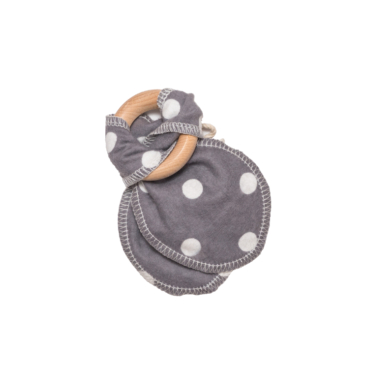 White polka dots on grey cotton teething ears that are attached to a maple wood ring.
