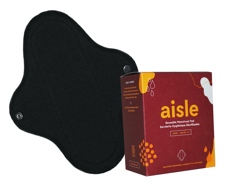 A black menstrual pad displayed with a red box labelled Reusable Menstrual Pad - Mini, by Aisle.