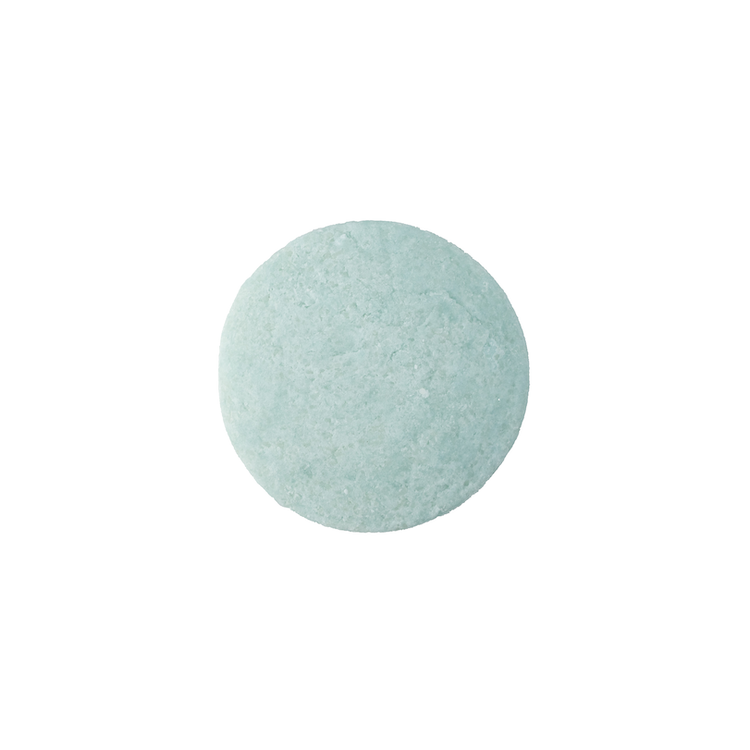 A single Be Bright Shampoo Bar that is round and light turquoise colour.