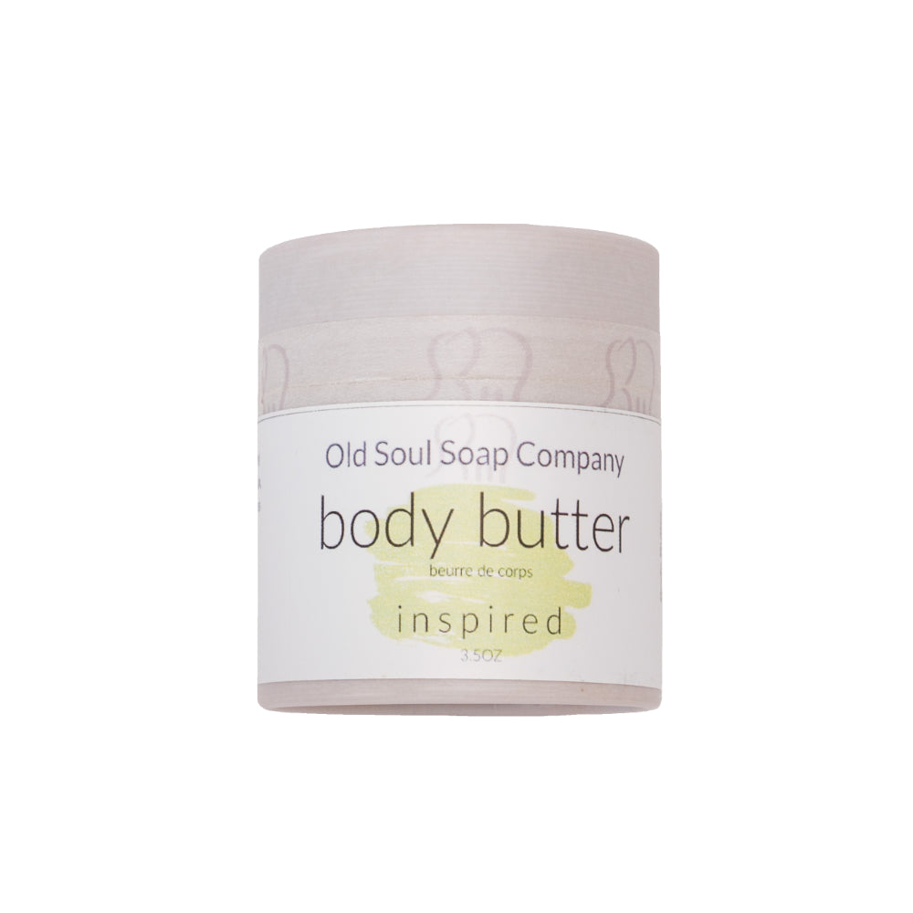 A grey cylindrical paper tube container labelled Body Butter in scent Inspired by Old Soul Soap Company.