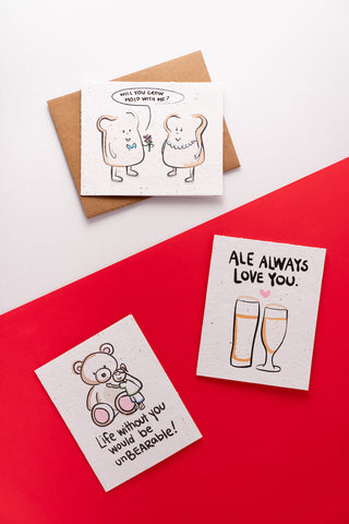Three love-themed greeting cards laid out on a half red half white surface.
